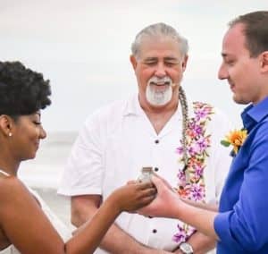 Wedding photos of Ceremony detailed beach wedding multi-racial couple