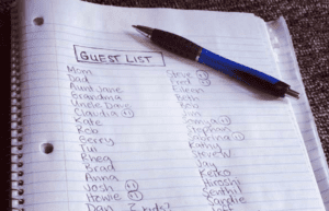 Guest list shown on notebook paper and pen