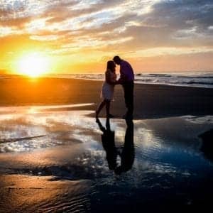 friend couple on beach at sunrise