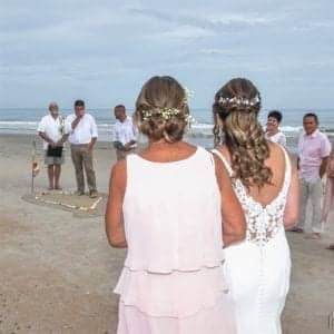 mom escorting bride on beach